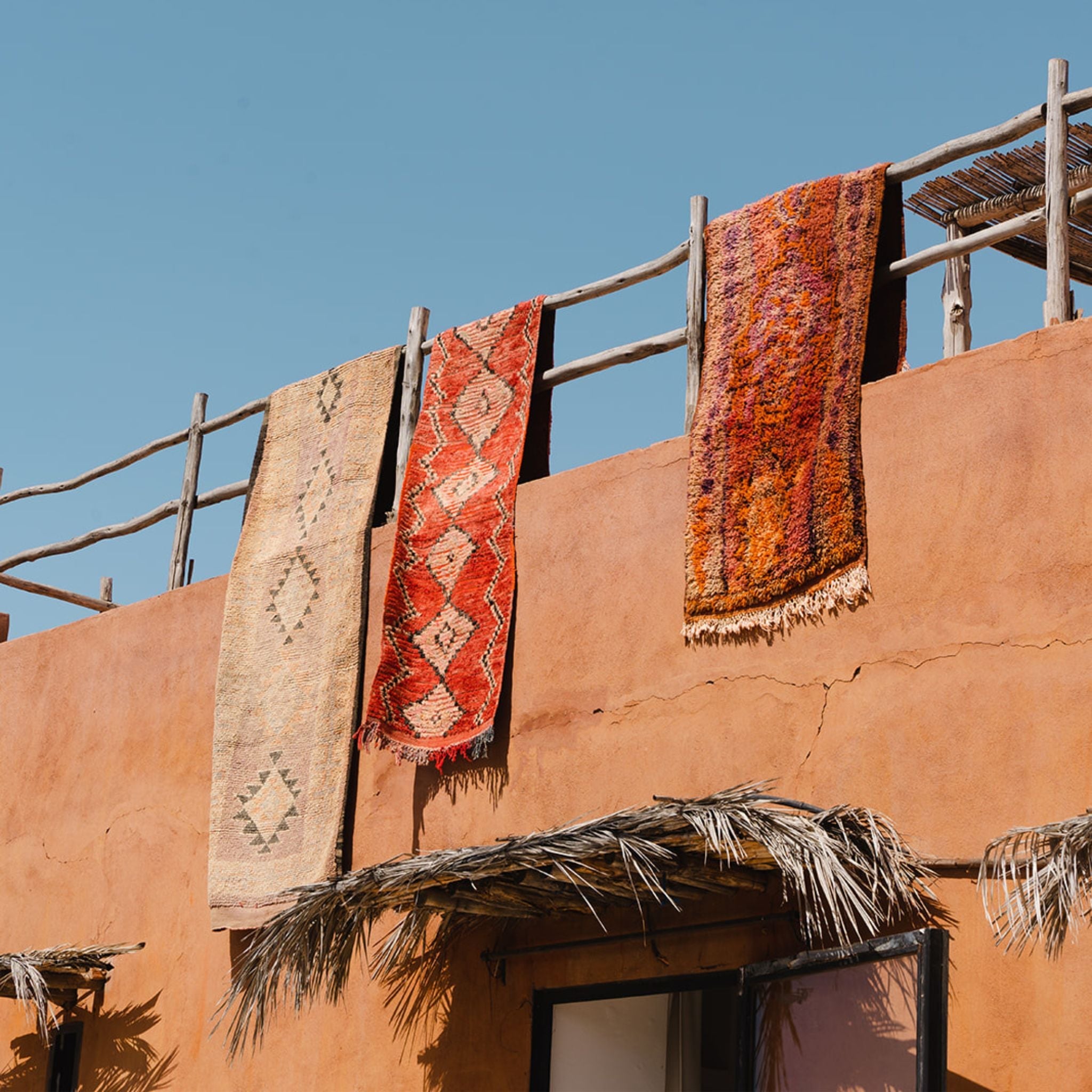 Moroccan hallway runners and runner rugs hanging in the sun - Nouvelle Nomad