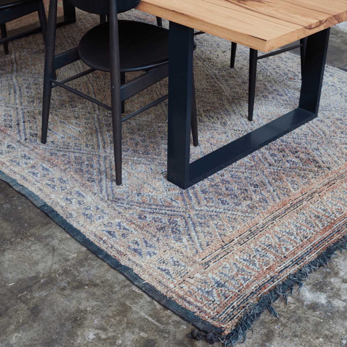 Blue and Terracotta coloured vintage Beni MGuild rug under a dining table - Nouvelle Nomad