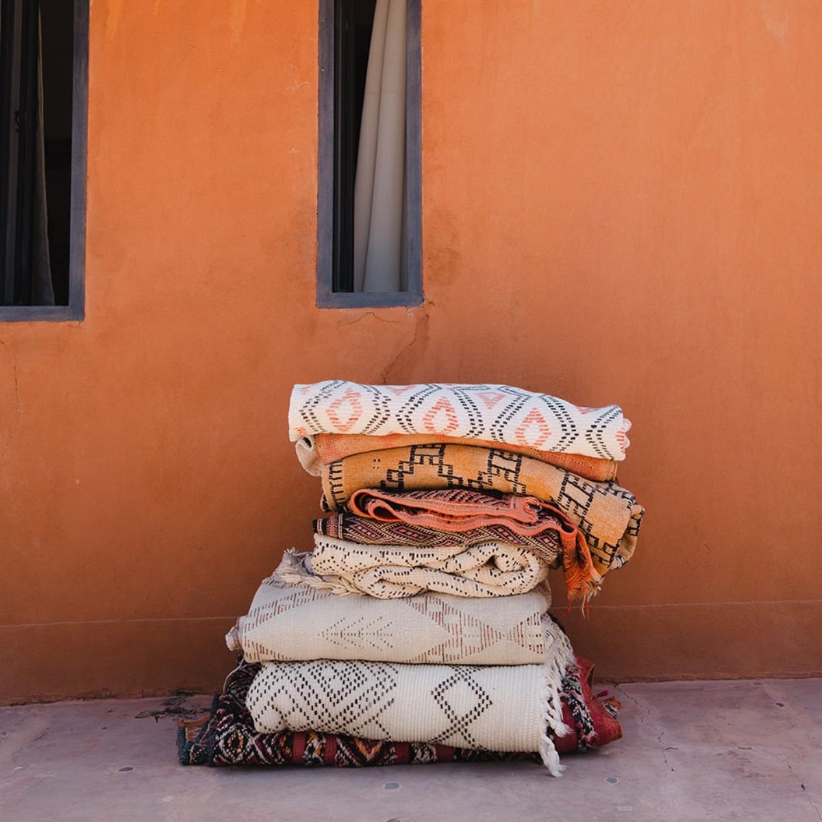 Moroccan Rugs Online - A pile of rugs stacked - Nouvelle Nomad