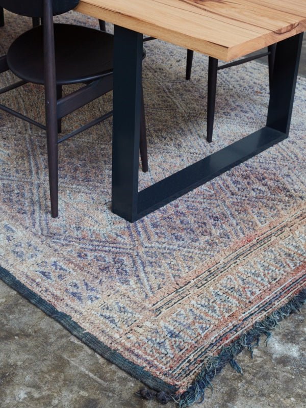 Vintage Beni MGuild Rug in Iris and rust colour under a Mark Tuckey dining table - Nouvelle Nomad