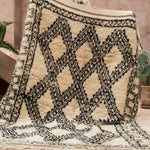 A shaggy high pile vintage Ben Ourain rug being held up - Nouvelle Nomad