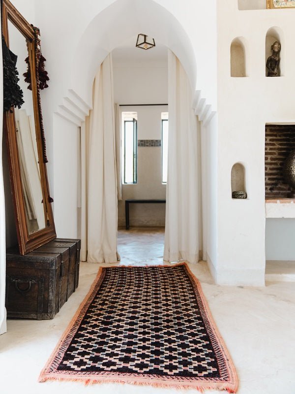 Black Moroccan runner rug on a white floor - Nouvelle Nomad