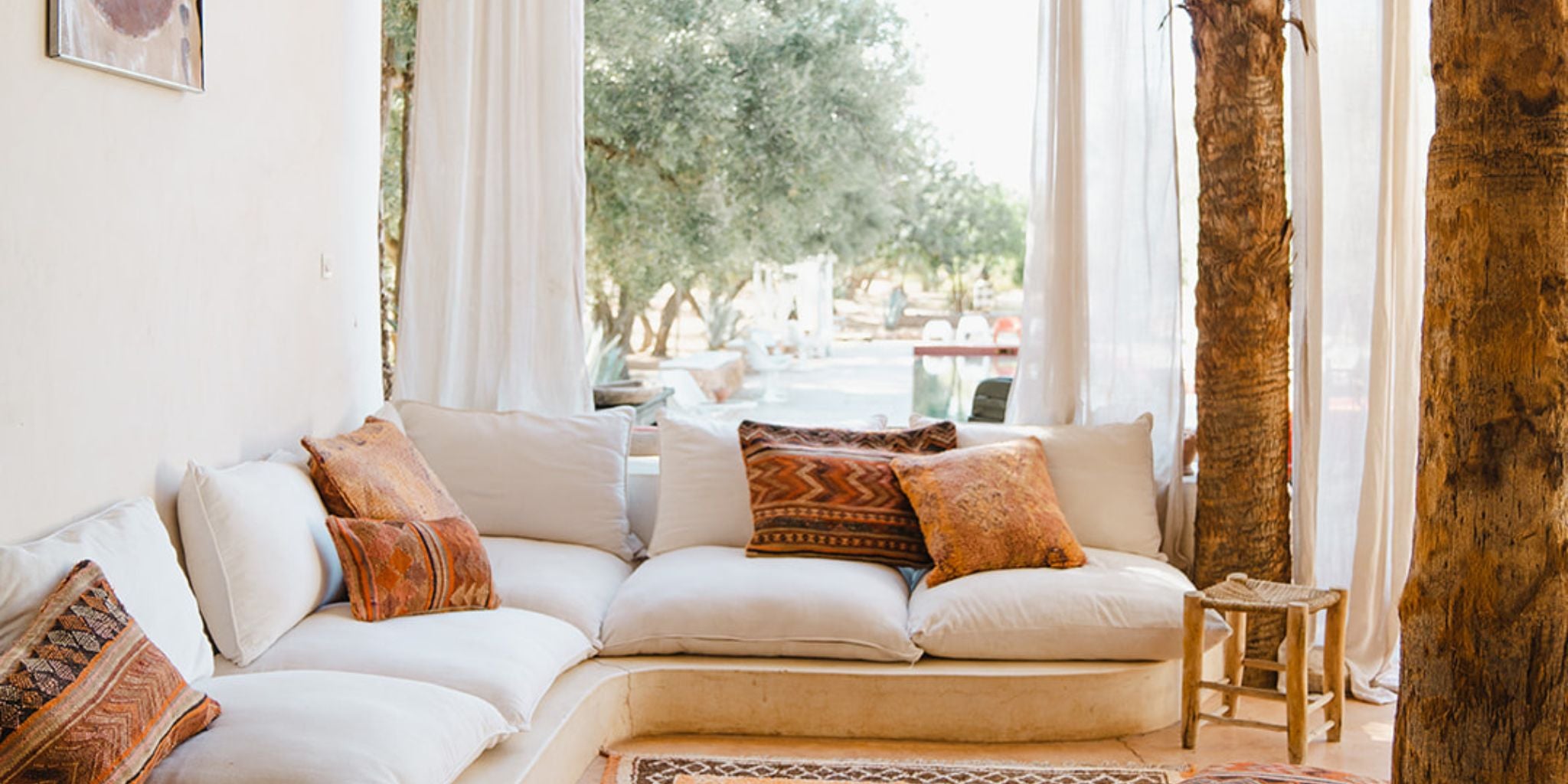 A Vintage Moroccan Rug and Cushions in in Marrakech Morocco - Nouvelle Nomad