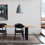 Beni MGuild rug under a timber dining table and chairs - Nouvelle Nomad