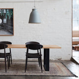 Beni MGuild rug under a timber dining table and chairs - Nouvelle Nomad