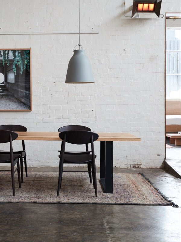 Beni MGuild rug under a timber dining table and chairs - Nouvelle Nomad